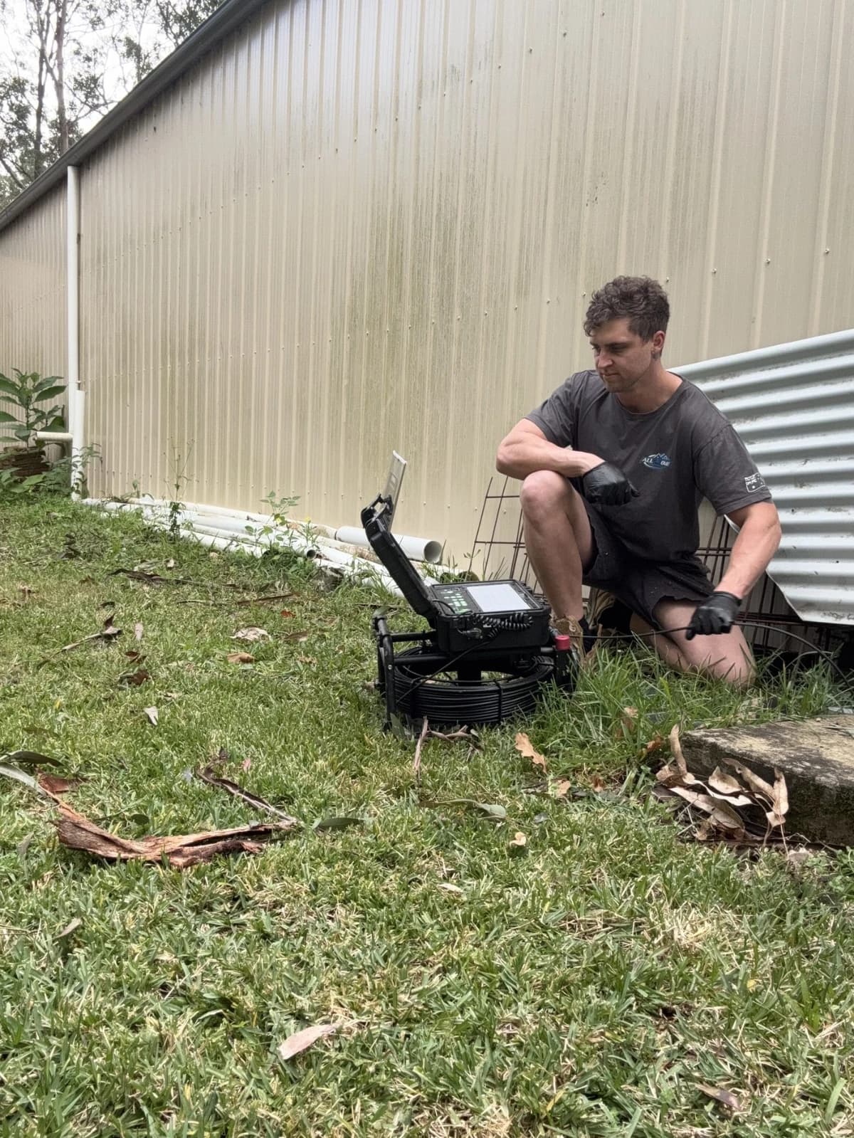 Josh inspecting a drain with a CCTV camera