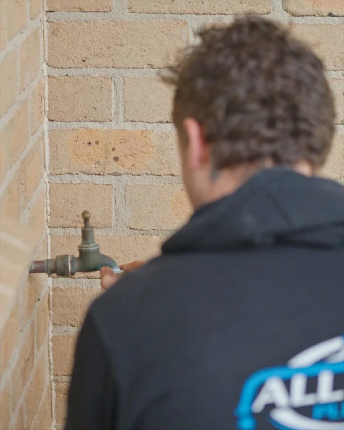 An outdoor tap and exposed pipework